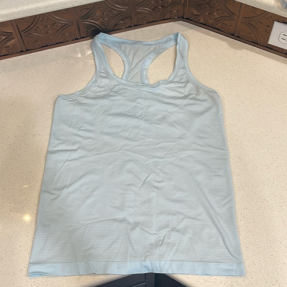 Lululemon light blue tank. Size 10 womens. Tiny brown spot inside hem.
